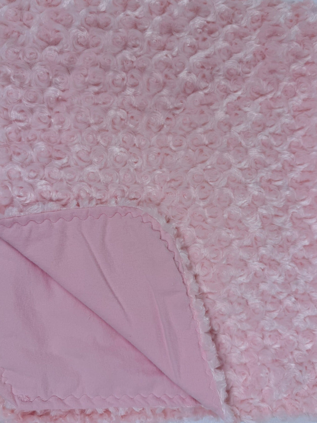 Pink textured blanket on a white background