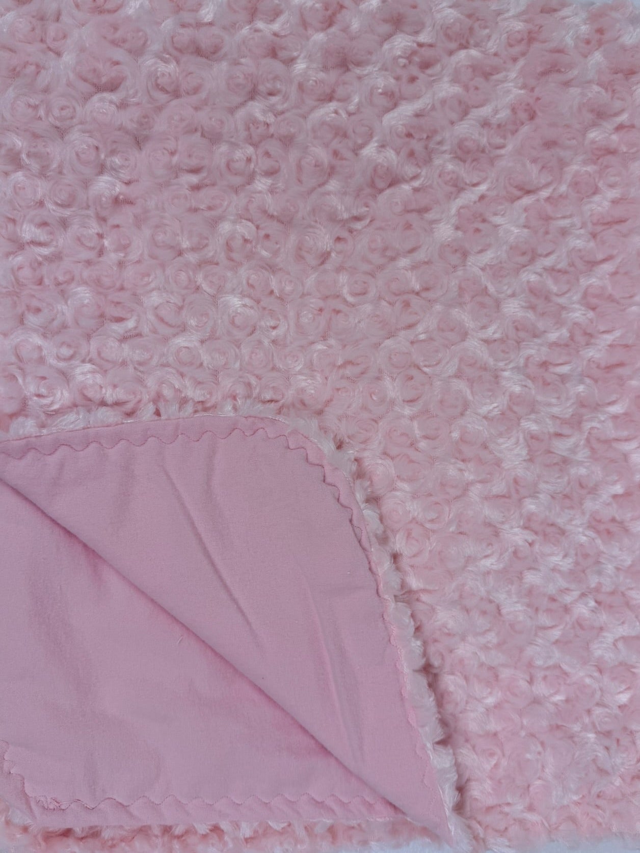 Pink textured blanket on a white background